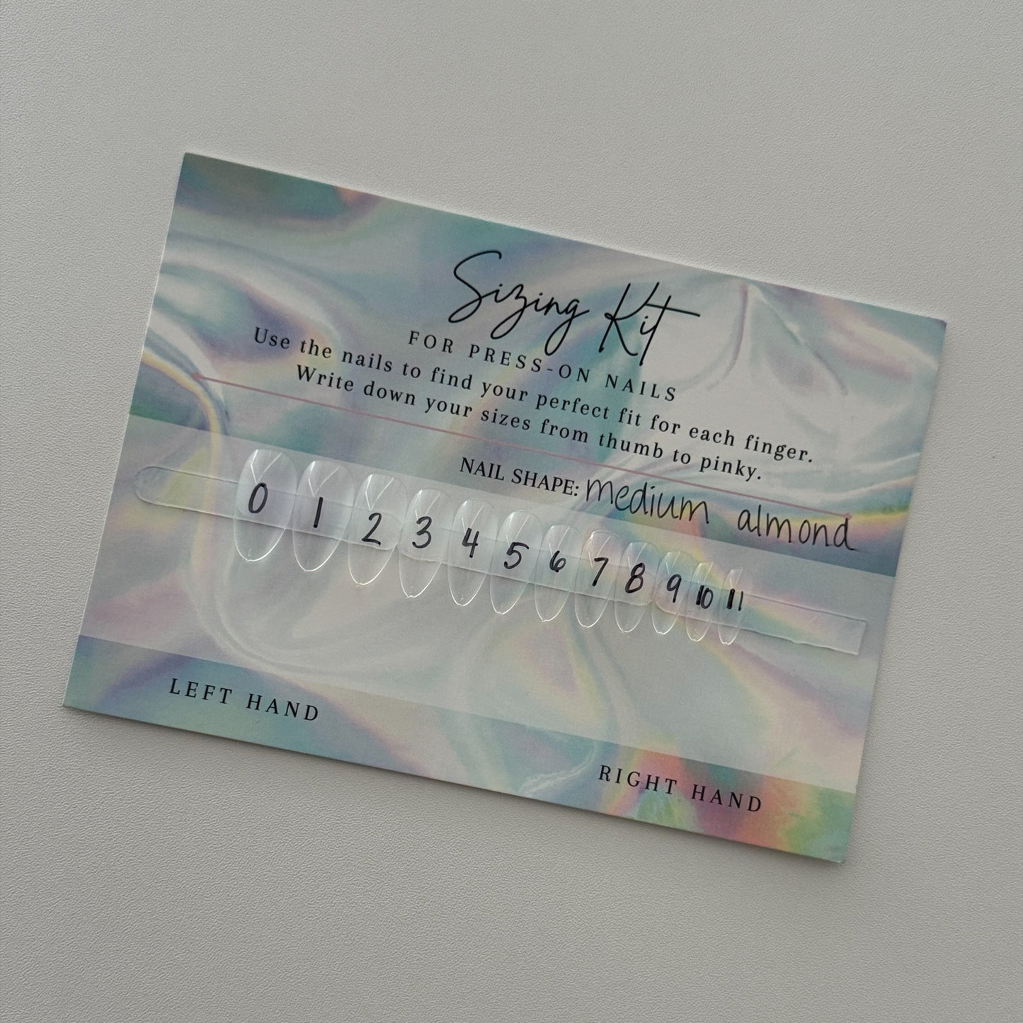 Nail art kit with color swatches and size chart on a gray background
